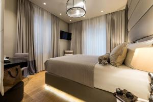 a hotel room with a large bed and a desk at Fortuna Luxury Rooms 1 in Split