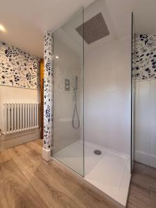 a shower in a bathroom with a glass enclosure at Peckforton cottage totally refurbished in Beeston