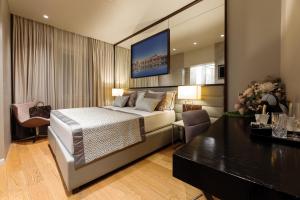 a bedroom with a bed and a tv on the wall at Fortuna Luxury Rooms 1 in Split