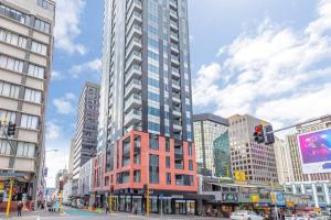 a tall building in the middle of a city at Apartment in Auckland City in Front of Sky Tower in Auckland