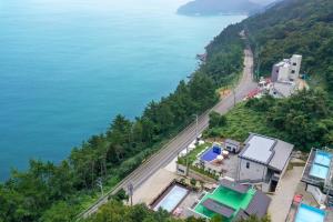 an aerial view of a road next to a body of water at Yeosu Tivoli Pension in Yeosu +10 photos