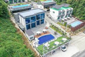 an aerial view of a house with a swimming pool at Yeosu Tivoli Pension in Yeosu