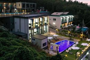 an aerial view of a house with a swimming pool at Yeosu Tivoli Pension in Yeosu