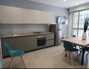a kitchen and dining room with a table and chairs at Playa-degli-Angeli-SCIROCCO in Gabicce Mare