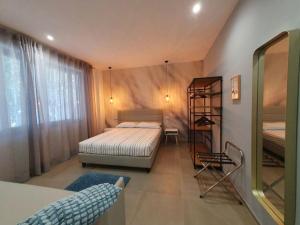 a small bedroom with a bed and a shelf at Playa-degli-Angeli-SCIROCCO in Gabicce Mare