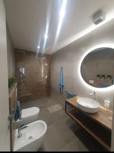 a bathroom with two sinks and a large mirror at Playa-degli-Angeli-SCIROCCO in Gabicce Mare