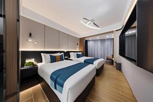 Postel nebo postele na pokoji v ubytování 颐程City View Hotel-广州太古汇珠江新城体育中心石牌桥地铁站店-广交会专享 + 37 fotografií