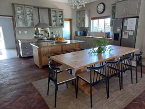 a kitchen with a large wooden table and chairs at Spacious Modern Home, Paarl Winelands in Paarl
