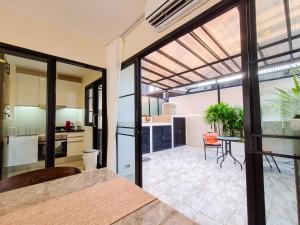 an open kitchen and living room with glass doors at 3br Townhouse Laguna Park in Layan Beach