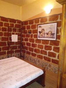 a room with a brick wall with a bed in it at Shemera Villa in Beruwala +18 photos