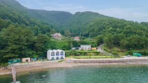 an aerial view of a resort on the shore of a body of water at Tongyeong Maremio Oceanview Pension in Tongyeong +15 photos