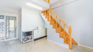 a staircase in a white room with a sink at Pocheon Swimpyo Pension in Pocheon +18 photos