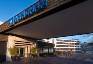 a building with a sign on top of it at Wyndham Stuttgart Airport Messe in Stuttgart