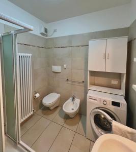 a bathroom with a washing machine and a toilet at Garden Thermae in Nago-Torbole +38 photos