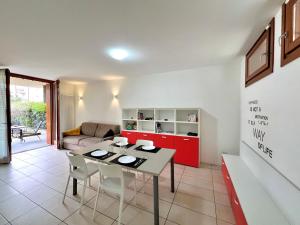 a living room with a table and a couch at Garden Thermae in Nago-Torbole