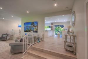 a living room with a staircase and a clock on the wall at Creek Side Summit home in Stateline