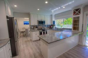 a large kitchen with white cabinets and a counter top at Creek Side Summit home in Stateline