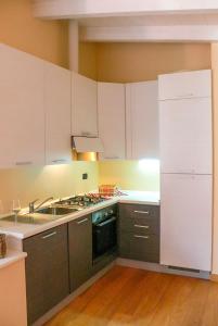 a kitchen with a sink and a stove top oven at Le Corti in Cannobio