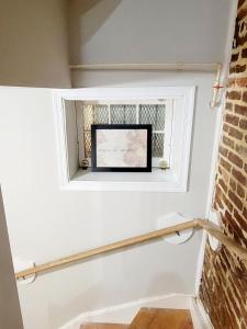 a window in a room with a brick wall at Whole House Walking Distance Stadium Free Parking in Baltimore