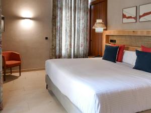 Postel nebo postele na pokoji v ubytování Tradere Hotel Boutique