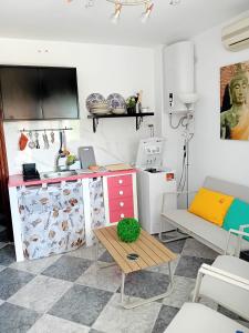 a kitchen with a counter and a table in a room at Salicia Alamos Beach in Torremolinos
