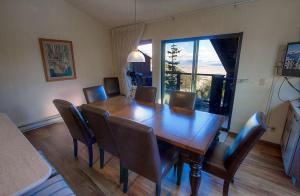 a dining room with a wooden table and chairs at Lakescape condo in Stateline +19 photos