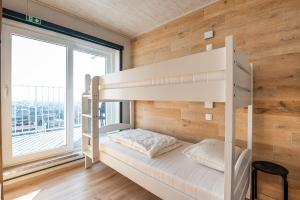 a bunk bed in a room with a large window at Nice apartment with suberb Sea Views in De Haan