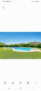 a picture of a pool of water in a field at Villa Jacqueline in San Roque in La Alcaidesa