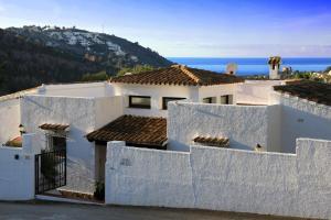 a white house with a view of the ocean at Isla Bonita Rental Home Moraira in Moraira