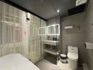 a bathroom with a shower and a toilet and a sink at M&H Cinema in Ho Chi Minh City