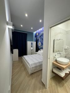 a bedroom with a bed and a sink and a mirror at Matera's Flats By Dimorra in Naples