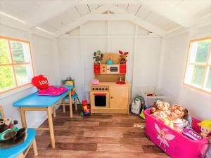 a childs play room with a table and a play kitchen at Pokoje Mariola in Karwia