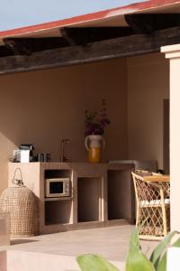 a kitchen with a counter with a microwave at Formentera Especial in La Savina