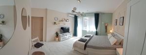 a bedroom with a bed and a television in it at Varna Moreto in Varna City