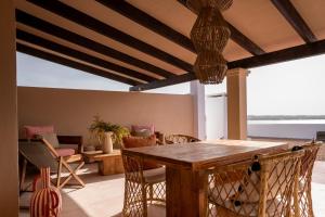 a living room with a wooden table and chairs at Formentera Especial in La Savina