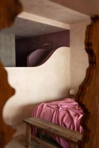 a bedroom with a bed and a wooden bench at Formentera Especial in La Savina