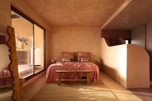 a bedroom with a bed and a table and a window at Formentera Especial in La Savina