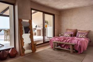 a bedroom with a bed with a mirror and a table at Formentera Especial in La Savina