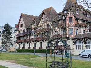 a building with a bird cage in front of it at Appartement refait à neuf en 2025 in Cabourg +5 photos