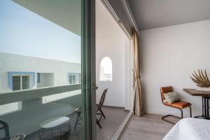 a room with a bed and a table and a window at Formentera Especial in La Savina