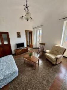 a living room with a couch and a table at Casa Fabrizio in Villa Viani +22 photos