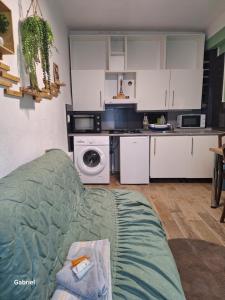a kitchen with a couch in a living room at Galamus Bonheur - Quand tu veux t'échapper de chez toi ! in Saint-Paul-de-Fenouillet