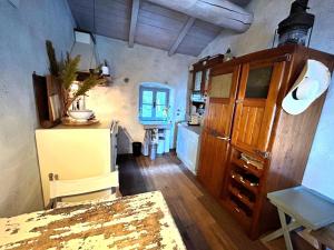 a kitchen with a table and a refrigerator in a room at San Fruttuoso Amazing Cottage in San Fruttuoso +16 photos