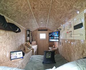a small room with a bed and a laptop in it at Little Home in Dierhagen
