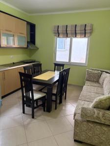 a living room with a table and chairs and a couch at STEFAN VASILI in Sarandë