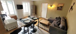 a living room with a couch and a table at Gîte La Canopée in Mariac