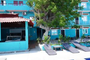 a blue building with benches in front of it at Hotel Vista Hermosa Aeropuerto Puerto Vallarta in Puerto Vallarta