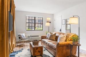 a living room with a couch and a table at Cozy Condo by Music Row Walk to Restaurants and Bars in Nashville +39 photos