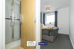a bedroom with a bed and a glass shower at Two Bedrooms Apartment By Vesta Serviced Accommodation & Short Lets Hatfield With Free WiFi in Hatfield