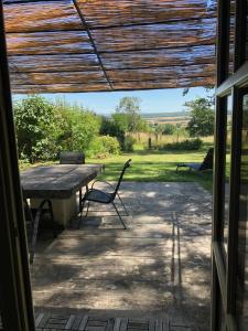 a table and chairs on a patio with a view at Tivauche in Corsaint